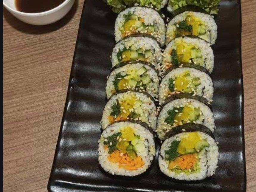 Korean kimbap seaweed rice rolls, sliced and plated